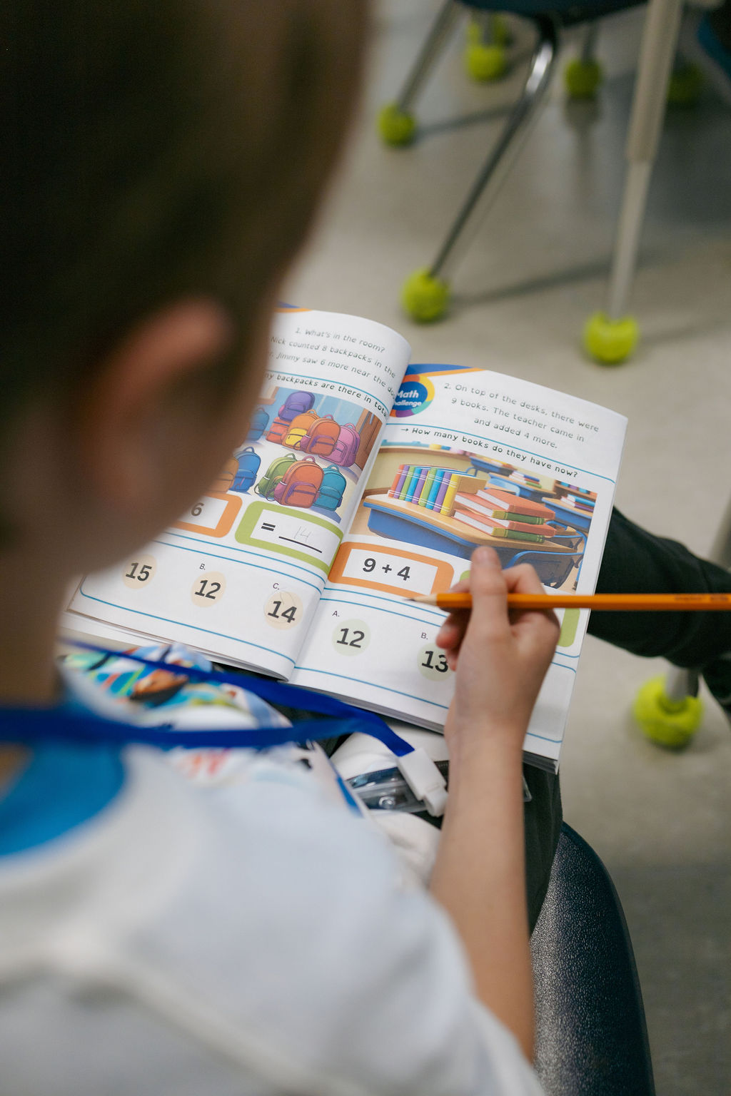 Child solving a hands-on workbook activity